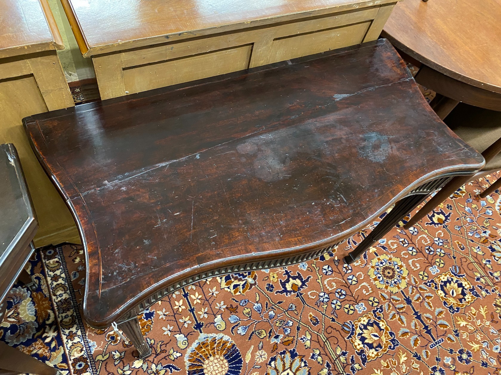 A George III mahogany serpentine folding card table, width 93cm, depth 48cm, height 72cm